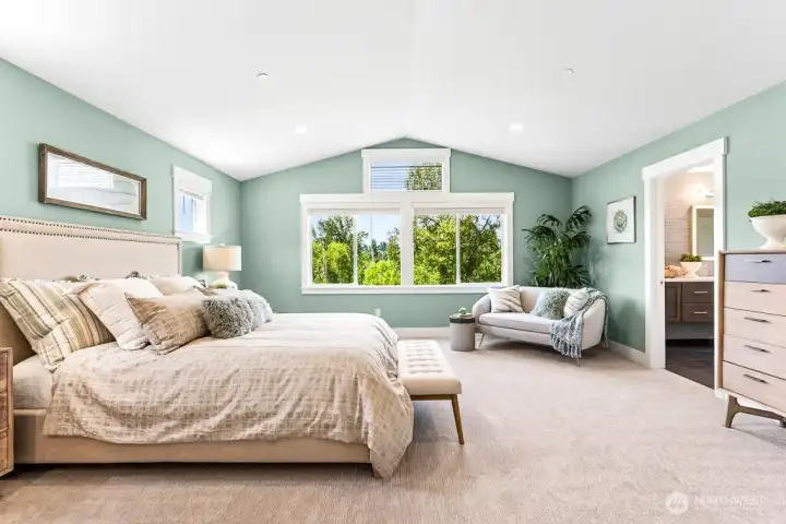 Primary retreat with vaulted ceilings and peaceful views.