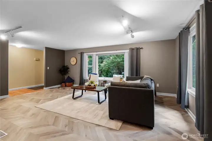 Looking back towards the front entry from the spacious living room with tons of natural light.