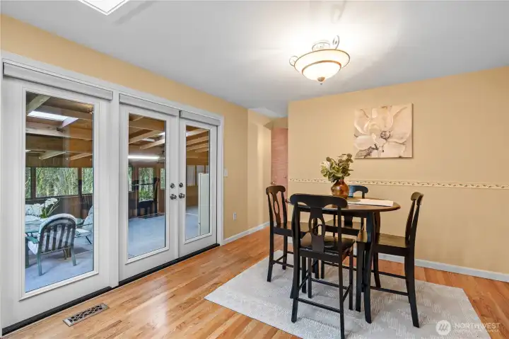 Additional dining area off of kitchen and leading into sunroom.