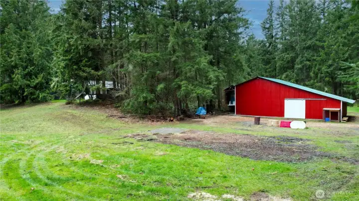 Back side of barn with sliding doors from the pasture side of the property