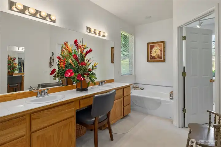 Extra Large dual sink vanity with soaking tub in primary bathroom.