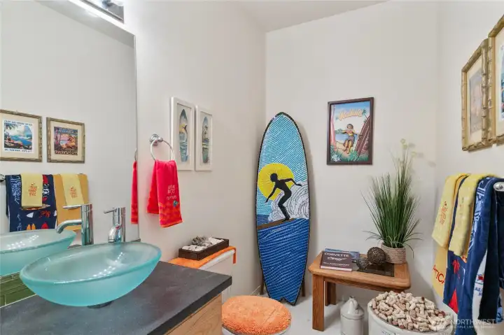 Hallway guest bathroom with custom sink and vanity.