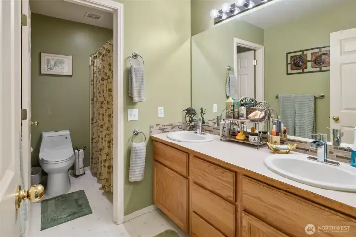 Full guest bathroom and dual sink vanity.