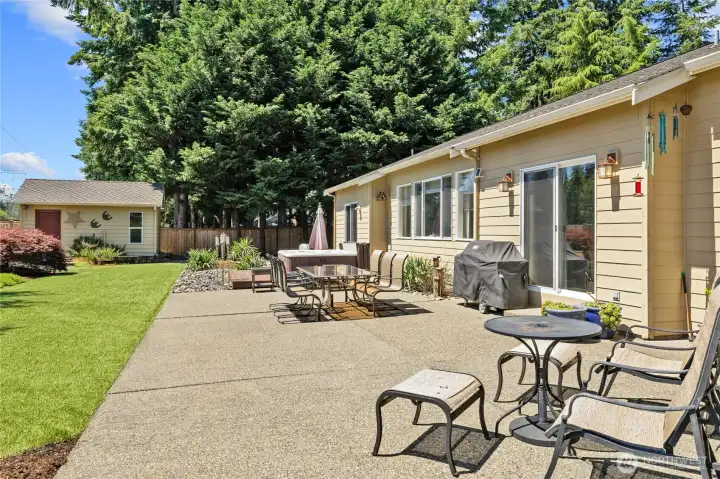 Your back yard oasis! Hot Tub, LARGE aggregate patio area and turf yard plus extra large storage shed with water and power!!!!