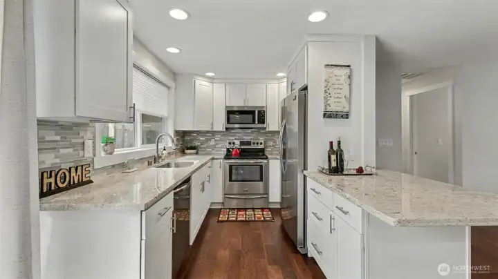 Quartz countertops, sleek cabinetry, and newer appliances.