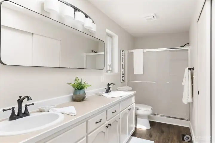 Shower big enough for 2 plus double sinks.  This bathroom is very roomy.  Closet doors to the right