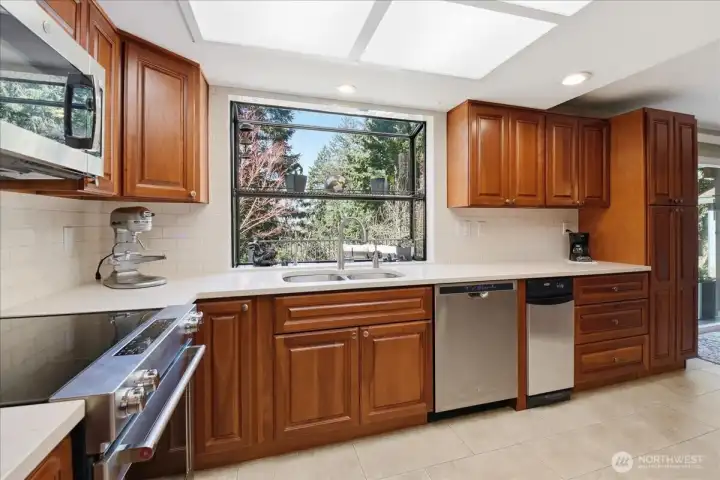 Kitchen with cherry cabinets and quartz counters