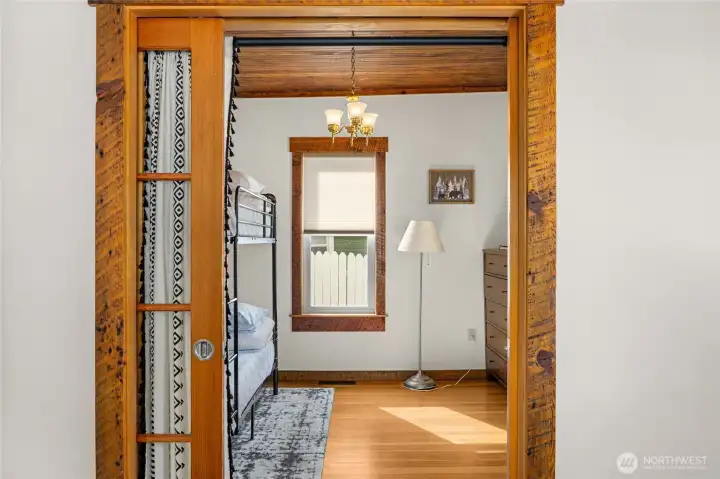 Endearing glass French doors into bedroom #2 on the main floor.
