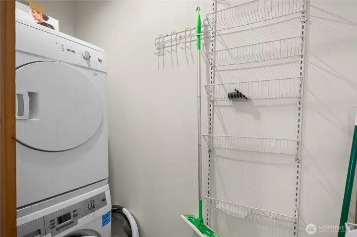 Full size stackable washers and dryer with extra storage makes this laundry area very useful.