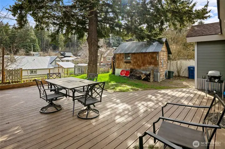 View of the oversized trex deck and cool cedar shake shed.