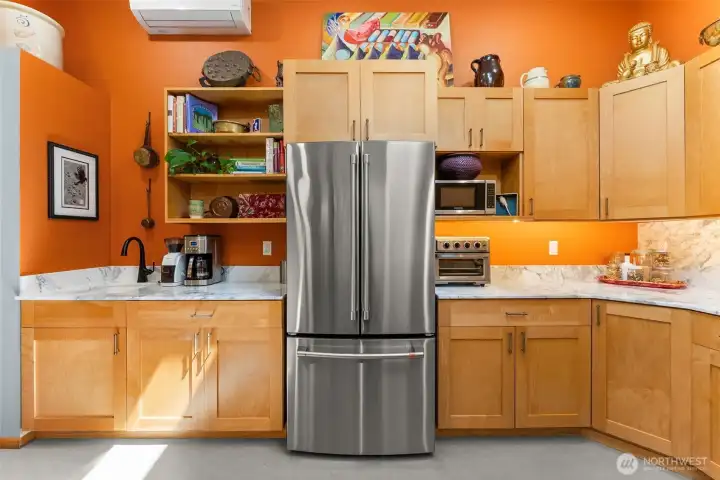 Stainless appliances, custom maple cabinets and marmoleum floors.