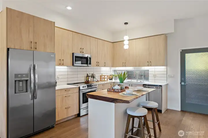 Beautiful modern kitchen with live edge slab on custom built island Beautiful modern kitchen with live edge slab on custom built island