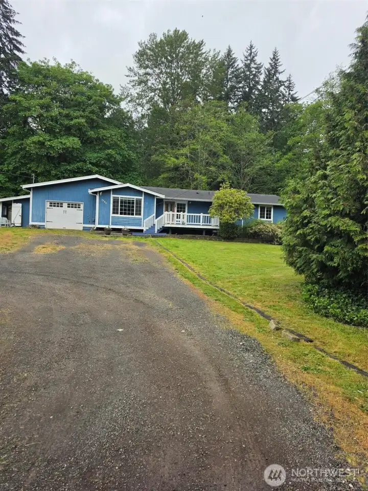 Gravel drive to one car shop/garage. Front window is office/den/family/bonus room