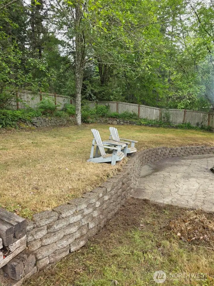 Upper back yard with Adirondack chairs that go with home and need some TLC.