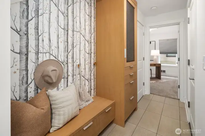 These gorgeous custom built-ins mean that shoes and outdoor items stay in reach but out of the way. Garage and bathroom to the right.