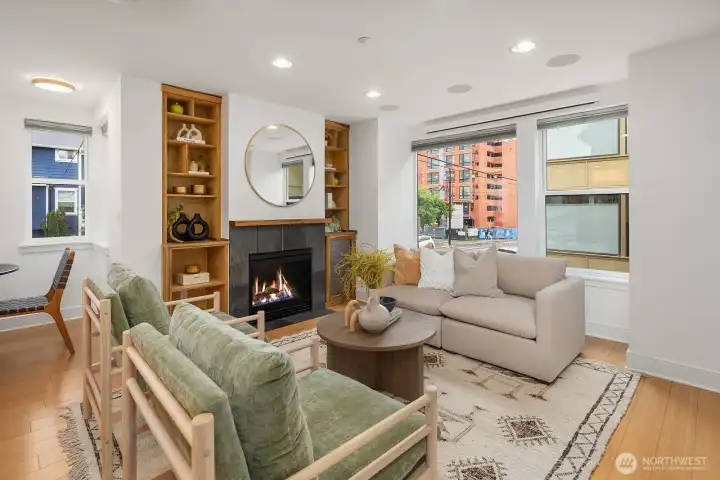 The gas fireplace, large windows, and built in custom projector make this living room feel special.
