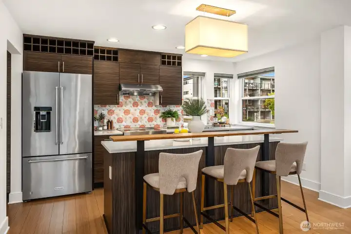 The gorgeous tile backsplash and wine storage add to the luxe feel.