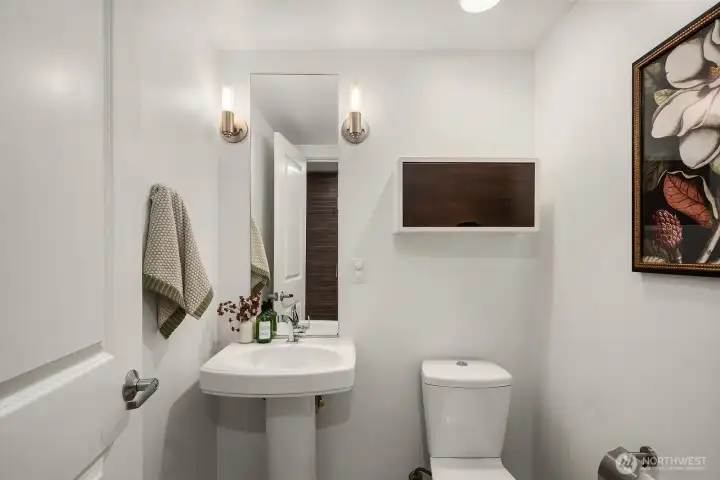 Half bath is in a private spot beside the pantry.