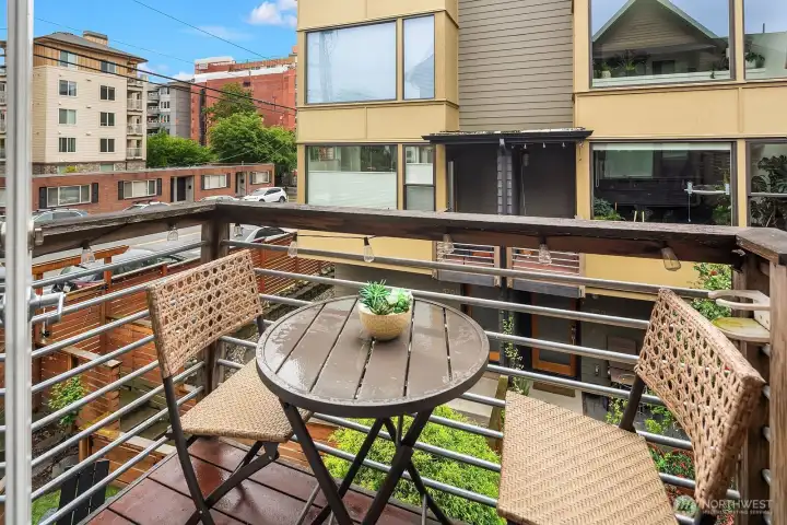 Just off the living area is a sweet balcony overlooking the lush yard.