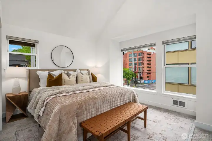 The primary suite feels spacious, with a vaulted ceiling and skylights.