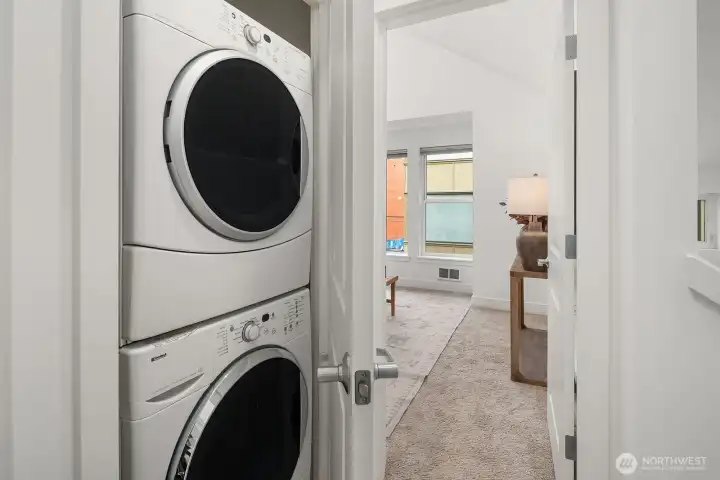 Stacked washer/dryer are conveniently located between the upper level bedrooms.