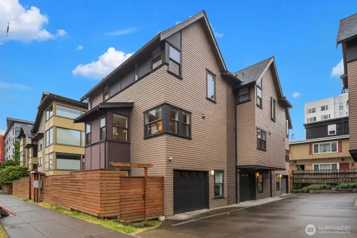 Enter the garage from the street. It has room for a car AND storage, gym/office area, etc. It even has windows so it feels like an extension of the home.