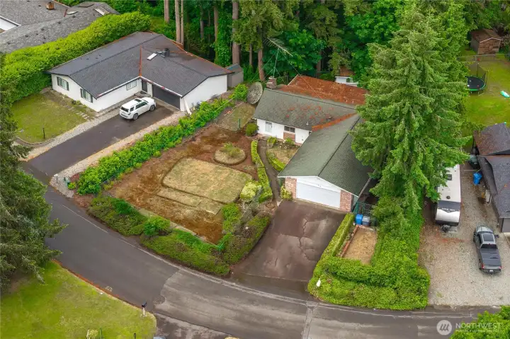 Aerial view of the lot - showing the garden beds in front, natural privacy shrubs surrounding it, and backing to Flett Creek, so you have a territorial VIEW!