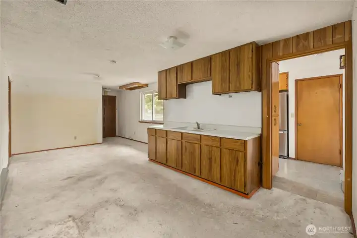 Large bonus room beyond the kitchen. The door straight ahead enters the 2-car, oversized garage. The door on the far left enters bedroom #4.