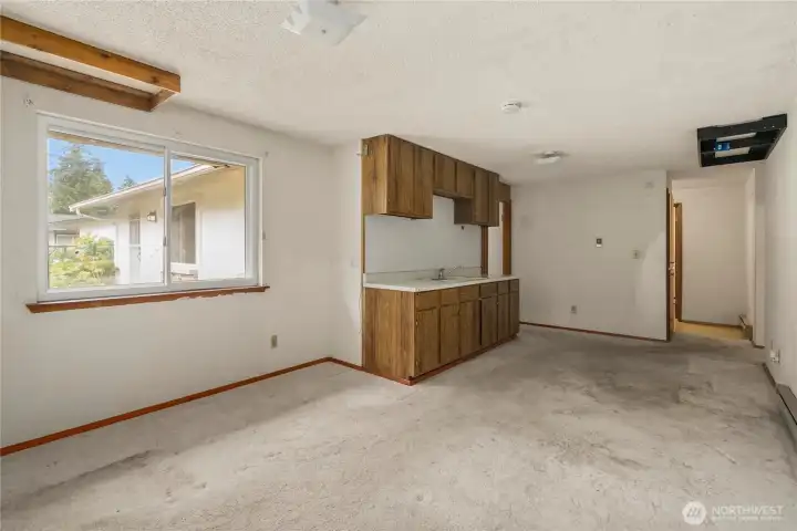 Looking back toward the kitchen (left) and the laundry & bathroom area (right).
