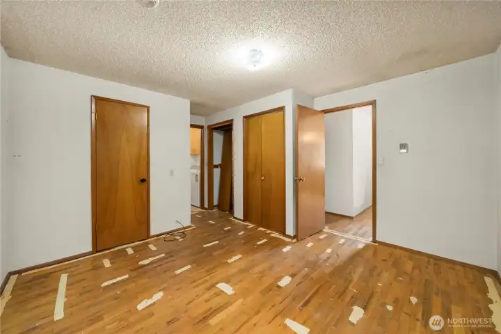 Primary bedroom enters from the living room, and is complete with a 3/4 bath (door on the left) and two separate closets. The laundry area is through the second door next to the closets.