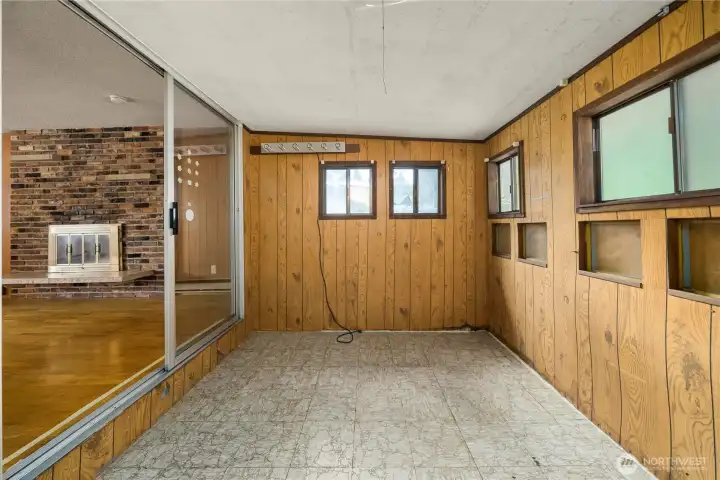 This Bonus room was used as a home office. It is located thru a sliding glass door at the end of the living room - fireplace visible on the left.