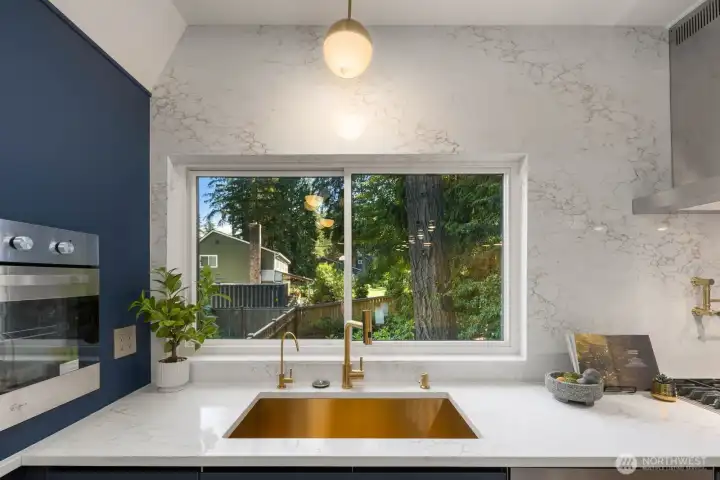 A full-slab quartz surround rises seamlessly from countertop to ceiling