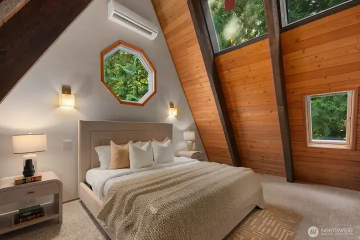 Primary bedroom with skylights and exposed beams from floor to ceiling