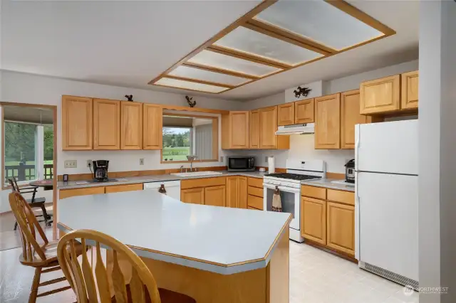 Large kitchen with island seating. Ample cupboard and counter space. Appliances stay!