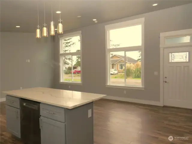 VIEW OF THE DISHWASHER UNDER THE ISLAND SEATING AREA PLUS VIEW OF THE AREA THROUGH THE LARGE WINDOWS!