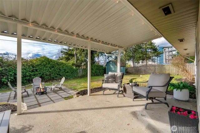 Backyard offers plenty of opportunities with lower firepit area & storage shed