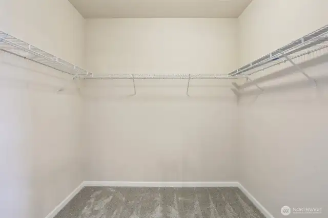 Walk in closet in the primary bedroom