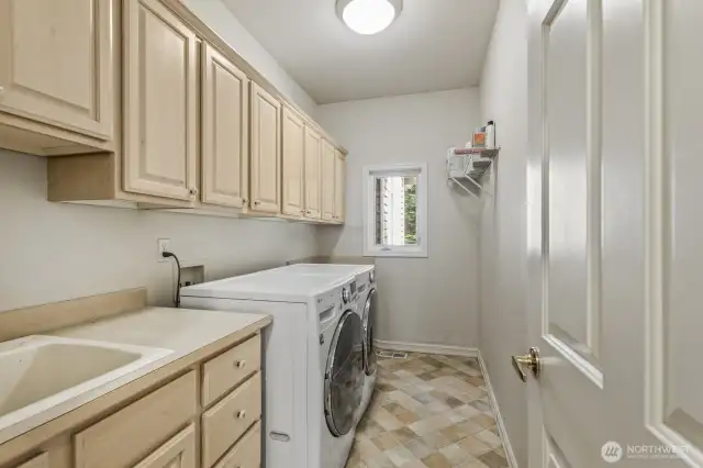 The main floor is completed with the guest ½ bath and laundry room with lots of cabinets and a utility sink.