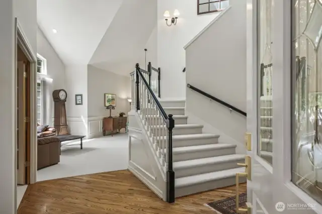 The double door entry opens into the voluminous wainscoted foyer with an oversized skylight and updated stairway.