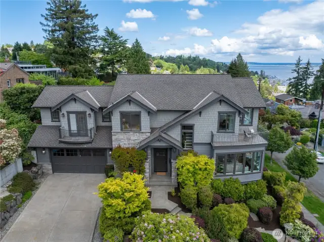 Welcome to Leschi-  On a serene Leschi street, this artfully curated residence captures sweeping views of Lake Washington, Mt. Baker, and the Cascades.