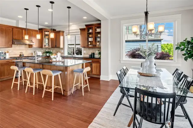 The open-concept main level features a central chef’s kitchen w/high-end SS appliances, flowing into bright living & dining areas—ideal for entertaining.