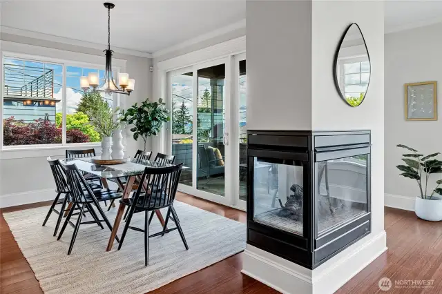 Gas fireplace is shared on both sides to the dining area and the open living room.