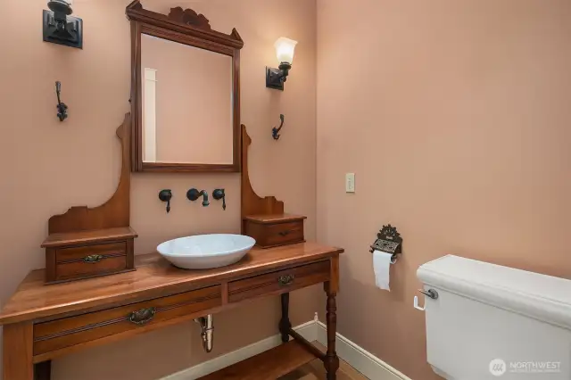 Powder bathroom with vintage vanity, vessel sink and wall mounted faucet