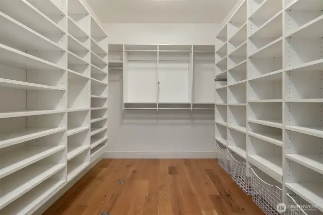 Primary walk-in closet with closet systems and auto light