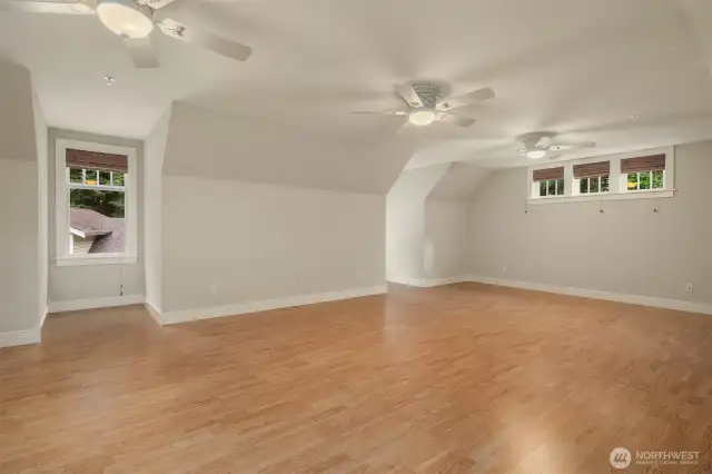 Flex room with private staircase entry, vaulted ceilings, ceiling fans, recessed lighting and window nooks
