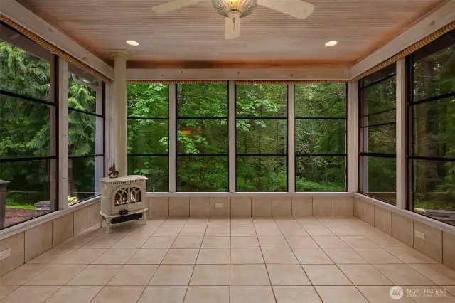 Double French doors to Sunroom with gas fireplace, ceiling fan, tongue and groove ceilings, collapsible windows, speaker system