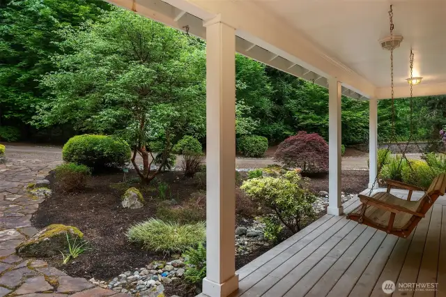 Covered wrap around front and back porch with cedar soffits and outdoor lighting.