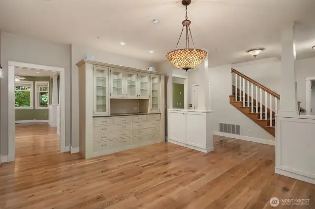Dining room with custom hutch and inset cabinets and slab counters
