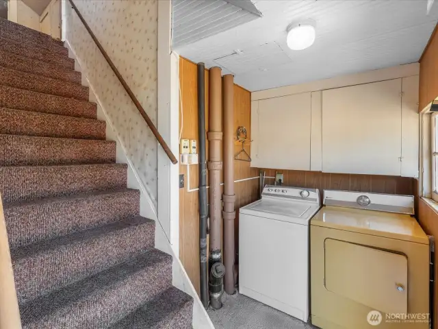 Utility room with stairs leading up to the 3rd bedroom plus bonus room.