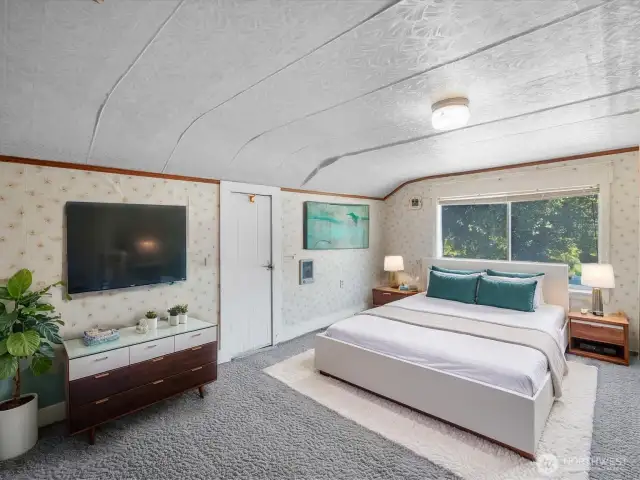 Large bedroom upstairs has room for a sitting area.    This image has been virtually staged to show the potential of the space.